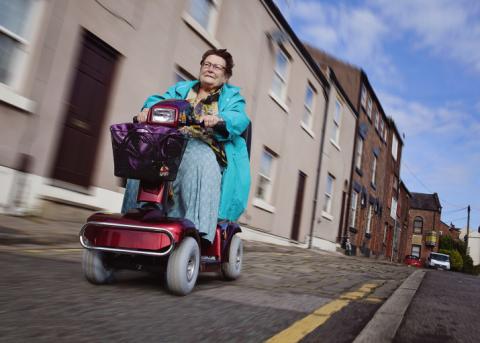 Image of a lady using a mobility scooter