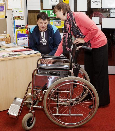 A volunteer demonstrating use of a wheelchair